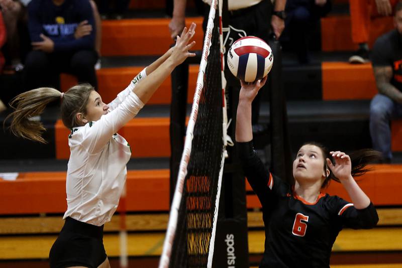 Crystal Lake South's Bobbi Wire tries to block the hit of Crystal Lake Central's Isabelle Lampier during the IHSA Class 3A Crystal Lake Central Regional volleyball final on Oct. 31, 2024, at Crystal Lake Central High School.
