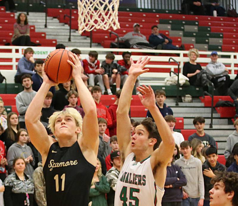 Sycamore's Burke Gautcher scores on a layup as L-P's Brendan Boudreau defends on Tuesday, Jan. 31, 2023 at L-P High School.