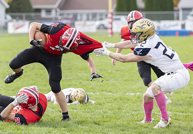 Amboy’s Troy Anderson looks to get away from Hiawatha’s Lucas Norvell Saturday, Oct. 28, 2023 in the I8FA playoffs in Amboy.