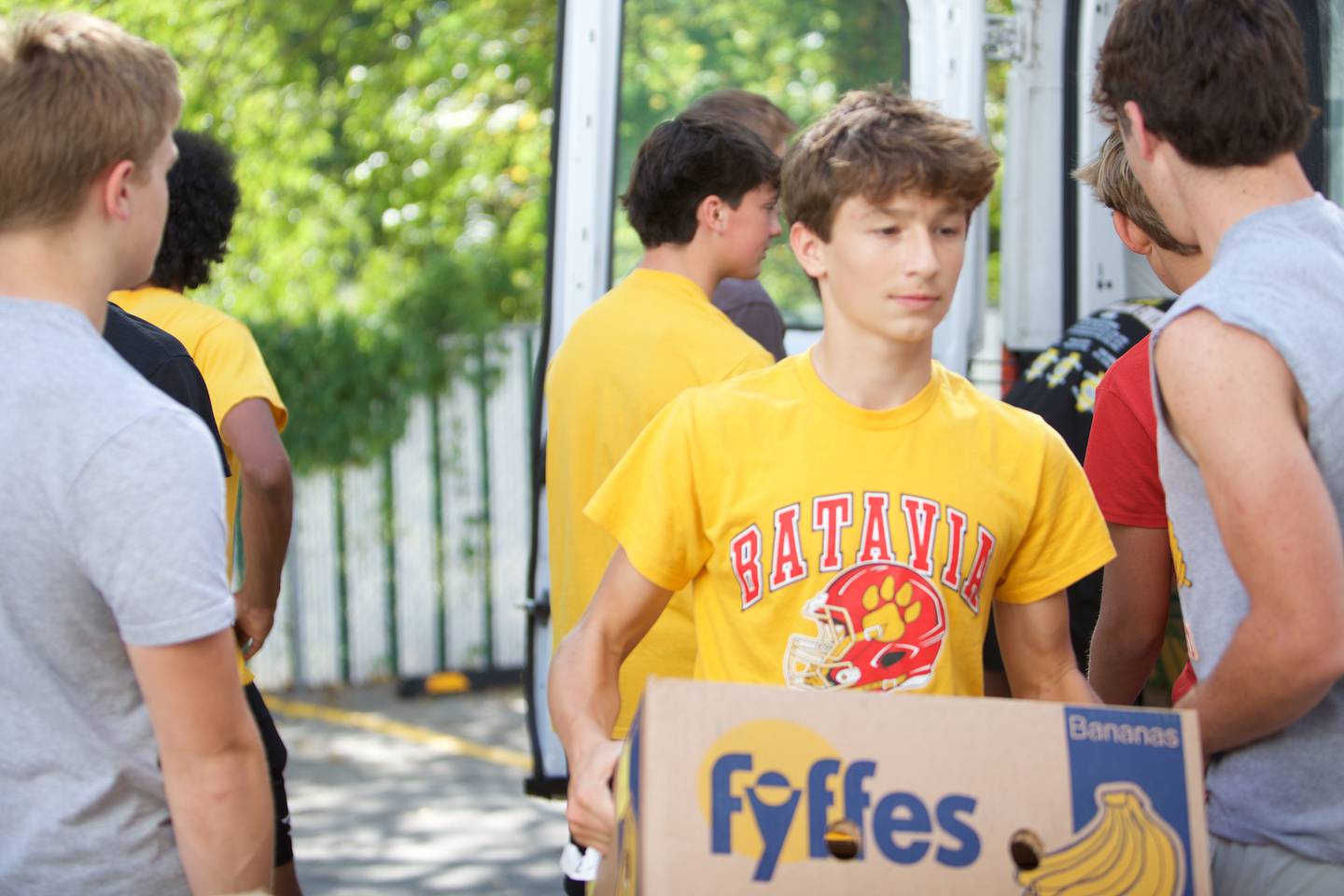Batavia High School Football players help move boxes into the new location of the Batavia Food Pantry on Saturday, Sept. 27,2025 in Batavia.