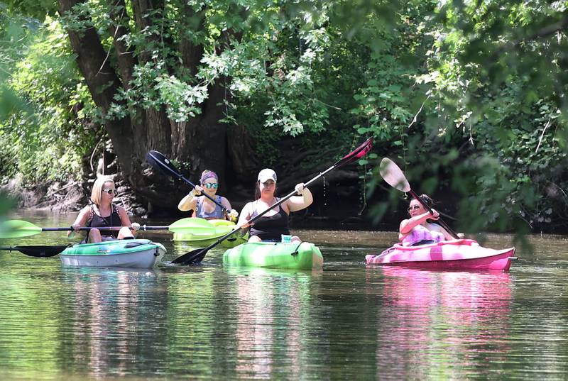 Kayakers paddle downstream in the Kishwaukee River Sunday, July 31, 2022, from the ramp at David Carrol Memorial Citizens Park in Genoa.