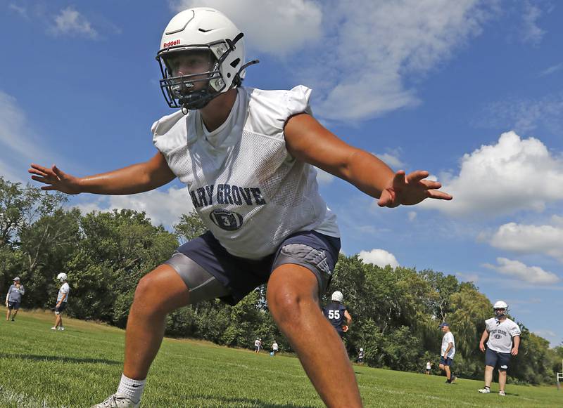Cary-Grove's Andy Bolf practices blocks after snapping the ball during Cary-Grove’s first football practice of the upcoming season on Monday, August 11, 2025, at Cary-Grove High School.