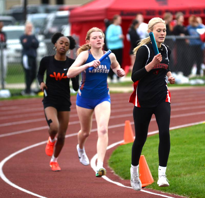 Forreston's Lucy Bawinkel, Genoa-Kingston's Jocelyn Abney, and Winnebago's Aariah Ingram run the first leg of the 4x800 relay at the Landers-Loomis Invitational track meet on Friday, April 25, 2025 held at Oregon High School.
