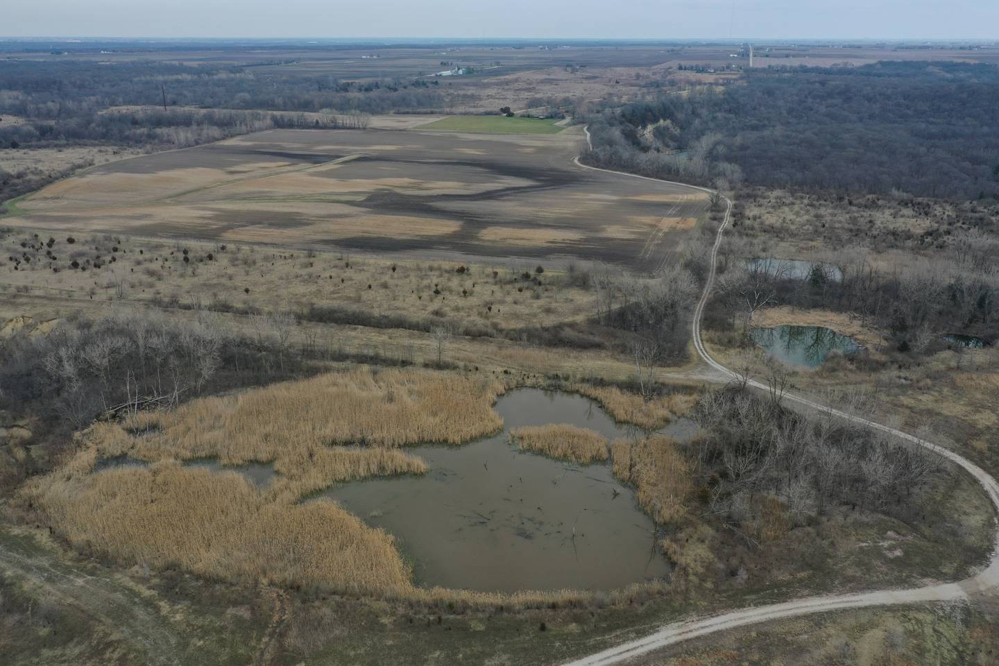 An aerial view of the Matthiessen Annex area on Wednesday, March 27, 2024 near Oglesby. The "green" area (top) is the Model Airplane Field at Matthiessen. In October 2018, the Illinois Department of Natural Resources purchased 2,628 acres from Lone Star Industries Inc. near Oglesby, Illinois in rural LaSalle County. This
formerly mined property is adjacent to Matthiessen State Park and is now referred to as the Matthiessen Annex property. In its reclaimed state, this property will provide recreational opportunities, as well as habitat and public access to the Illinois River and Bailey Creek.