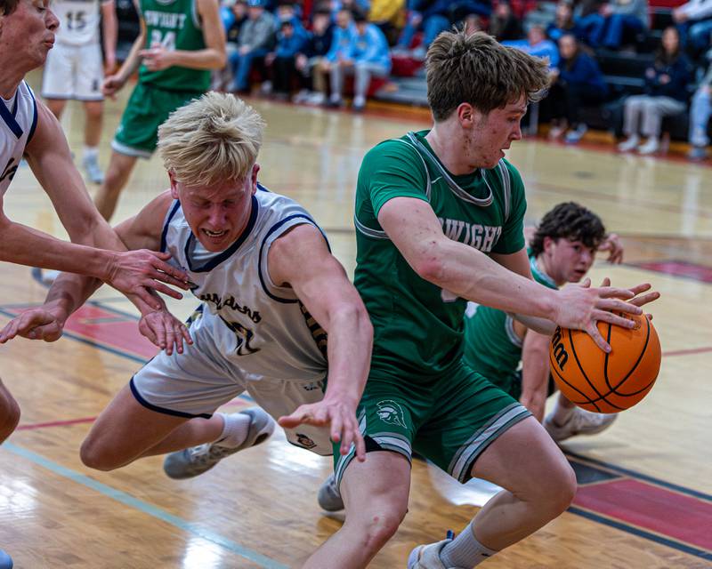 Dwight's Collin Bachand (3) grabs loose ball as Marquette's Luke McCullough (23) dives for possession on Saturday, Feb. 21, 2026 at Marseilles Elementary School.