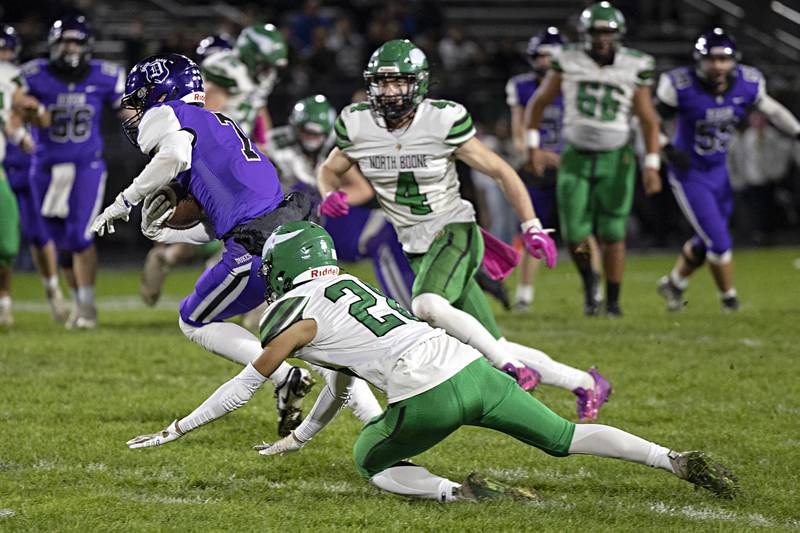 Dixon’s Cort Jacobson splits the North Boone defense Friday, Oct. 20, 2023 in Dixon.
