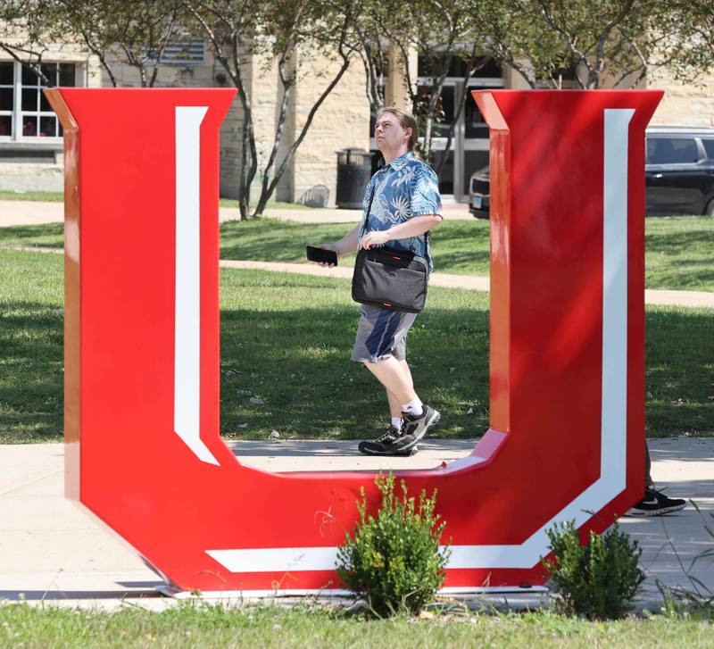 Northern Illinois University freshman accounting major Nathan Hoy, from Bolingbrook, walks past the NIU sign after class Wednesday, Aug. 24, 2022, on campus at NIU in DeKalb.