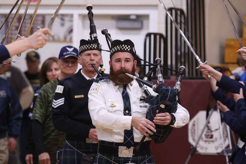 Member of the Chicago Police Pipes & Drum lead the procession of military veterans at the Lockport Township High School 10th Annual Veterans Night Celebration on Friday, Dec. 6, 2024.