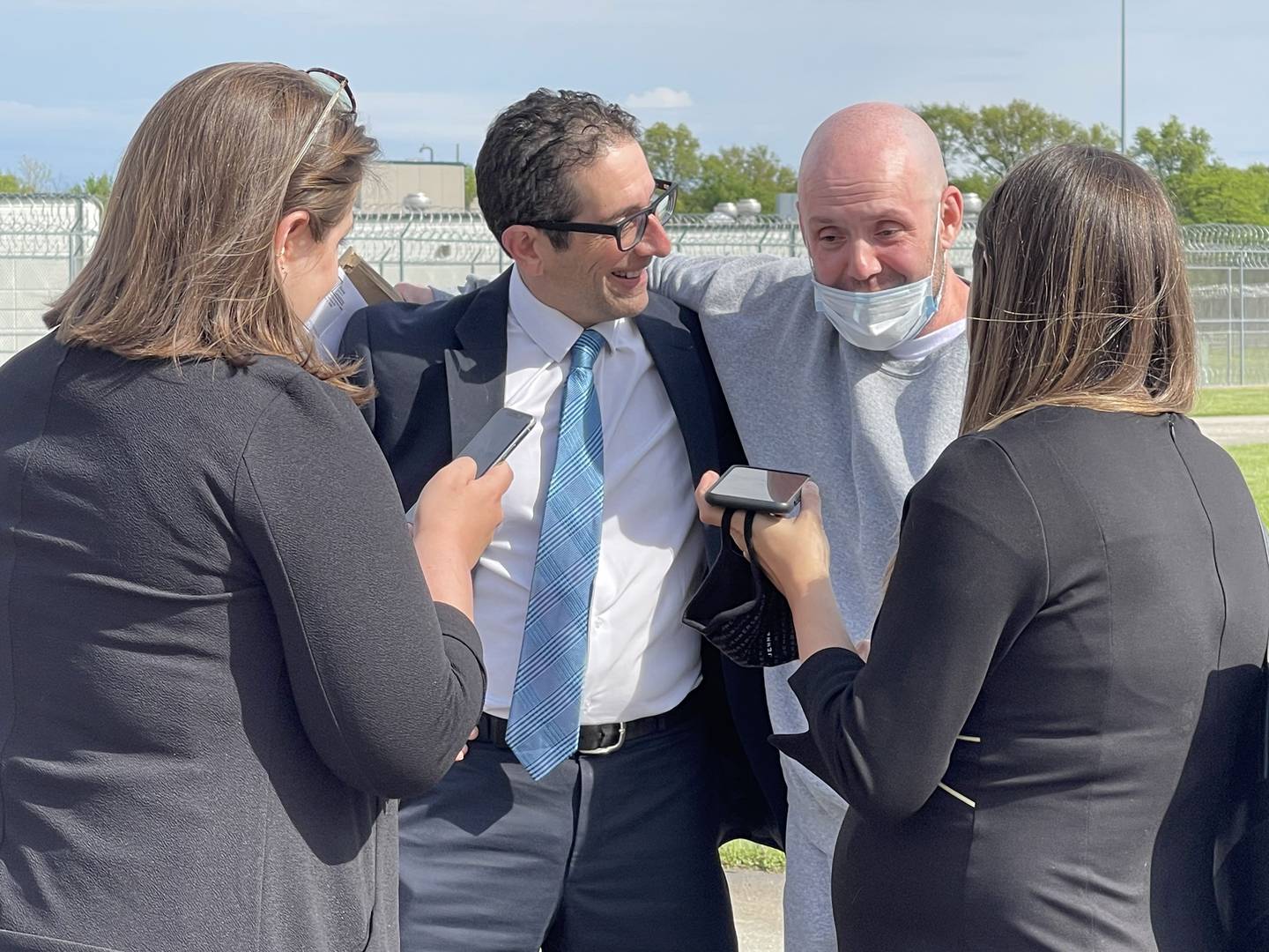 Kenneth Smith, 45, speaks to his family over the phone with his arm around attorney David Jimenez-Ekman after walking out of Lawrence Correctional Center in Sumner on Thursday, May 6, 2021. Smith was greeted by members of the law firm Jenner and Block of Chicago, who helped secure his release after serving nearly 20 years for the 2001 murder of Raul Briseno.