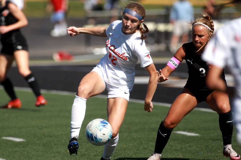 St. Charles East's Sophia Wollenberg kicks the ball away from Wheaton Warrenville South's Brooke Ittersagen during a game on Friday, May 16, 2025 in Wheaton.