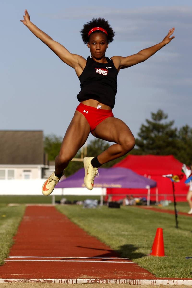 Huntley’s Dominique Johnson flies through the air as she long jumps during the Huntley IHSA Class 3A Girls Sectional Track and Field Meet on Wednesday, May 8, 2024, at Huntley High School.