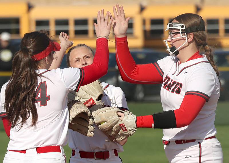 Ottawa pitcher McKenzie Oslanzi (right) is congratulated by teammates after a striking out a Sycamore hitter during their game Friday, April 21, 2023, at Sycamore High School.