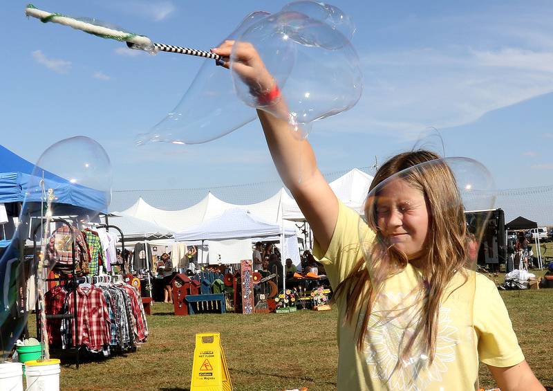 Aleena Higley of Dixon, reacts as a giant bubble pops on her face during the 26th Annual Pumpkin Harvest Craft Show. at Boggios Orchard and Produce on Saturday, Sept. 27, 2025 in Granville. This weekend featured the craft show, market, bakery, and pumpkin hill free of charge. There is a cost to take the kids to the play area which includes a jumping pillow, corn maze, wagon rides, a petting zoo, and playground.