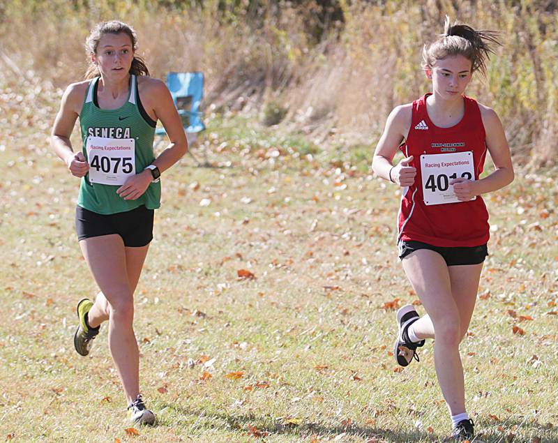 Seneca's Gracie Steffes and Henry-Senachwine's Mikayla Frawley run in the Class 1A Regional Cross Country gils race on Saturday, Oct. 22, 2022 at the Seneca FFA Farm in Marseilles.