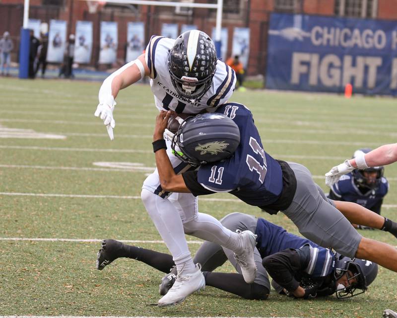 IC Catholic Prep's Grant Bowen (11) gains some yards before being brought down by Chicago Hope Academy’s Devin Mims (11) during the 3A Playoff game against on Saturday Nov. 1, 2025, held at Altgeld Park in Chicago.