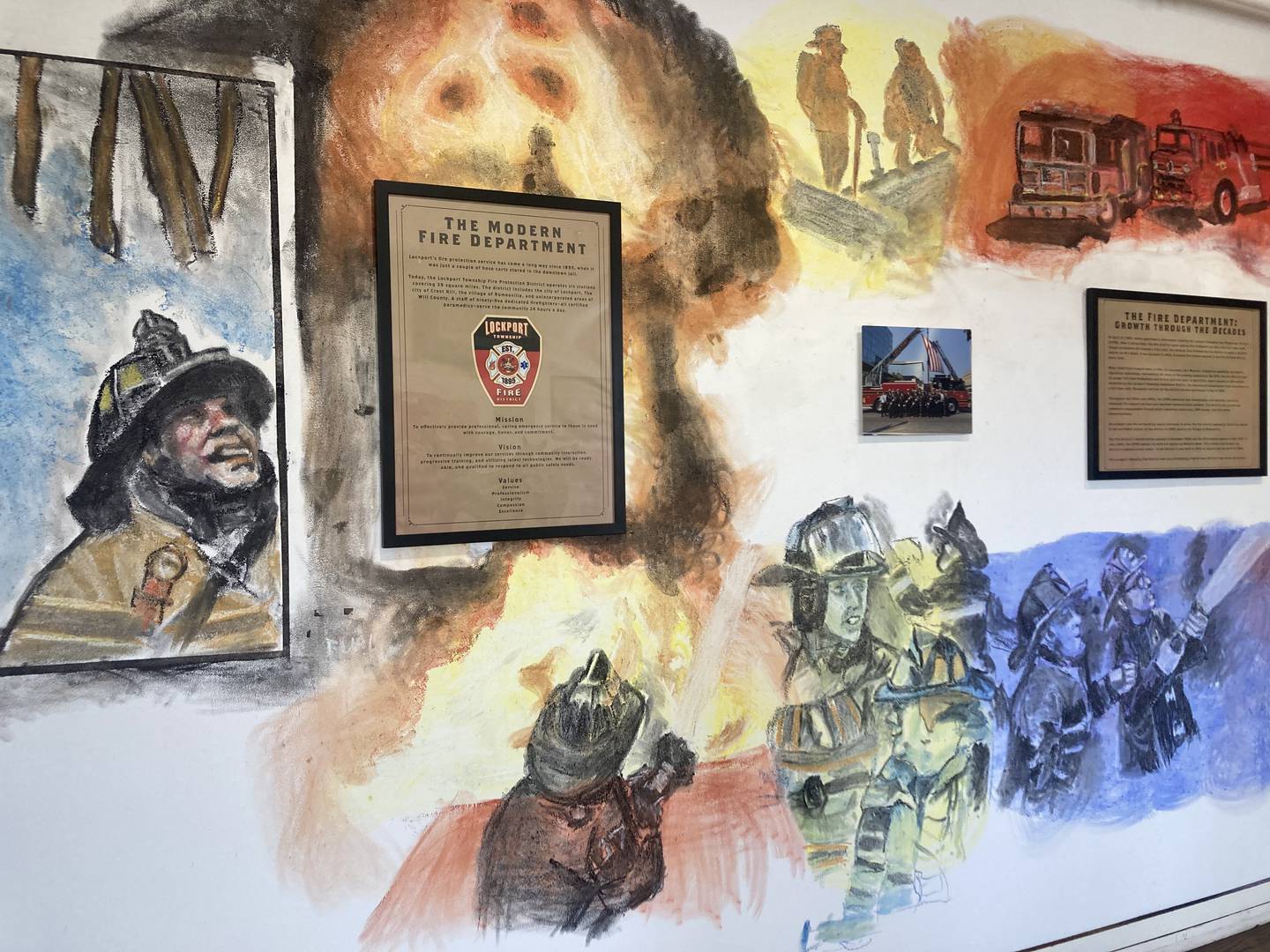 The final portion of the mural includes depictions of Lockport Fire Fighters and was drawn by Traynor after he injured his dominant right hand.