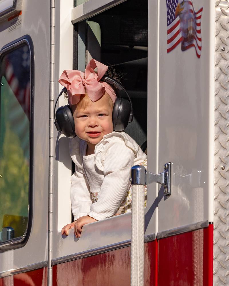 A child looks out the window of a fire truck during the Utica Veterans Parade and Airshow on November 2, 2025 in Utica.