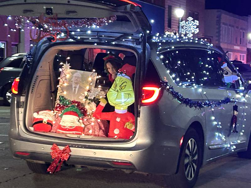 A vehicle heads down a city street in the lighted parade during Mt. Morris' Christmas in the Village on Saturday, Dec. 7, 2024.
