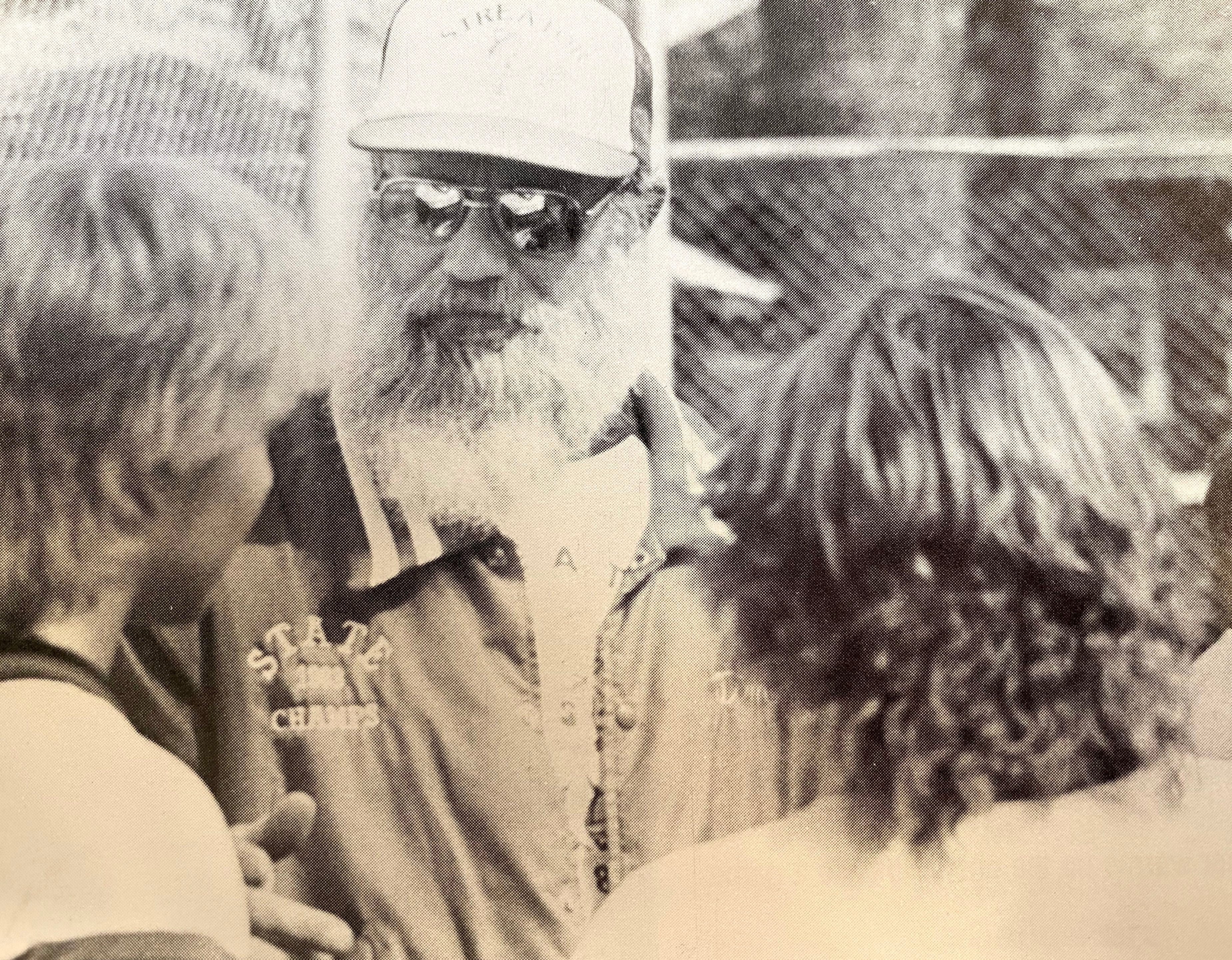 Head coach A.T. Mogill wears his 1983 state champs jacket while talking with players during the 1984 season.