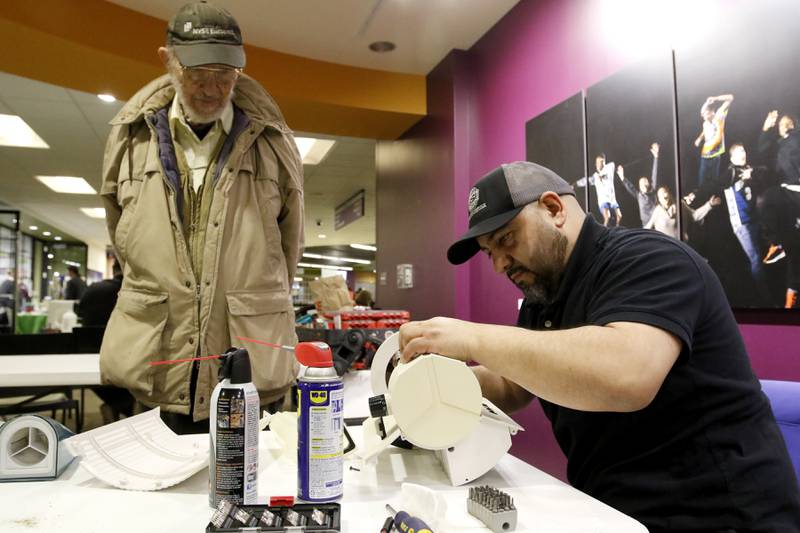Roger Farris, watch as Freddy Campovered tries to repair an expresso machine’s steam function during a Repair Fair on Tuesday, April 15, 2025, at McHenry County College.