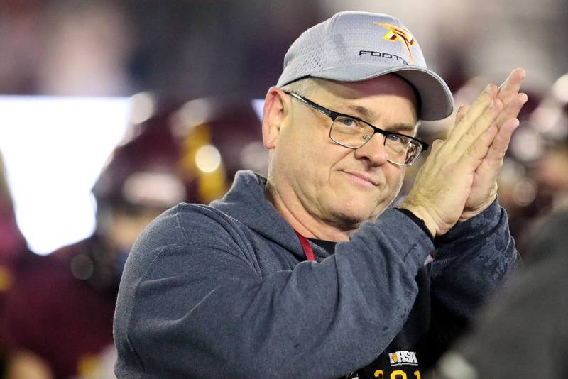 Richmond-Burton coach Mike Noll claps for his Rockets after defeating Murphysboro, 50-14, Friday for the Class 4A state championship in DeKalb.