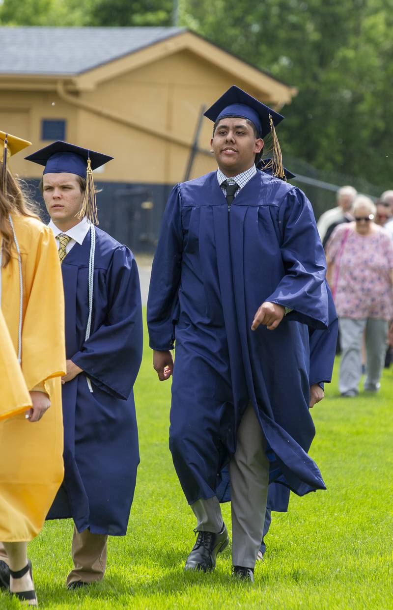 Oscar Robles Jr. walks into Marquette Academy's Gould Stadium Sunday, May 29, 2022, for the graduation ceremony.