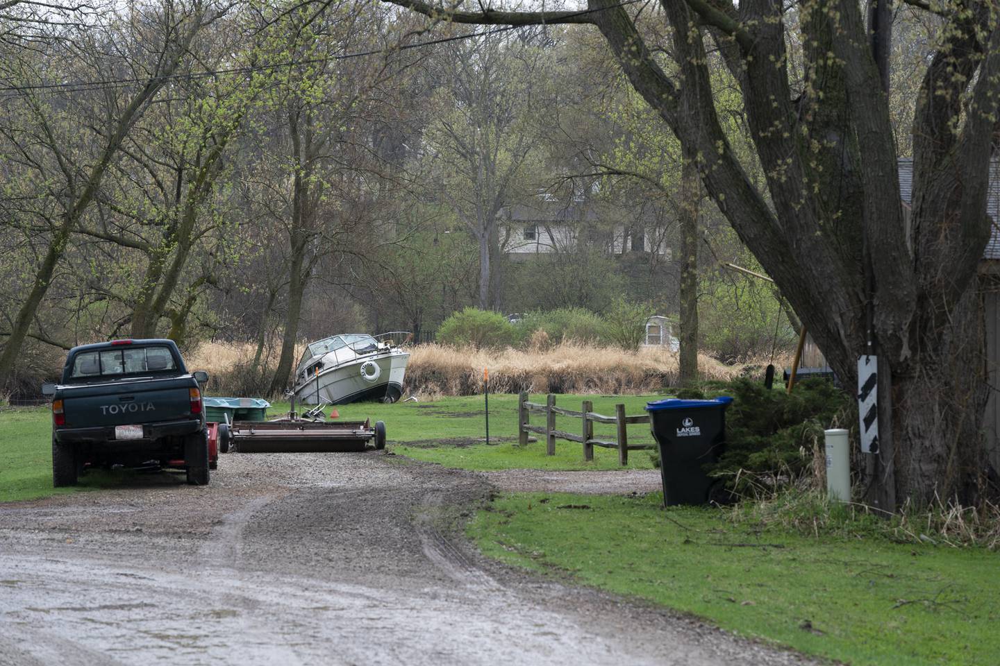 A boat rests on the shore on Saturday, April 10, 2021, in the Dubell Park neighborhood of Spring Grove next to the Nippersink Creek that is prone to heavy flooding.