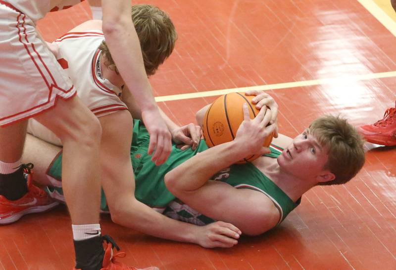 L-P's Braylin Bond holds a loose ball in the paint as Ottawa's Jack Carroll arrives late to the ball on Friday, Feb. 6, 2026 in Kingman Gymnasium at Ottawa High School.