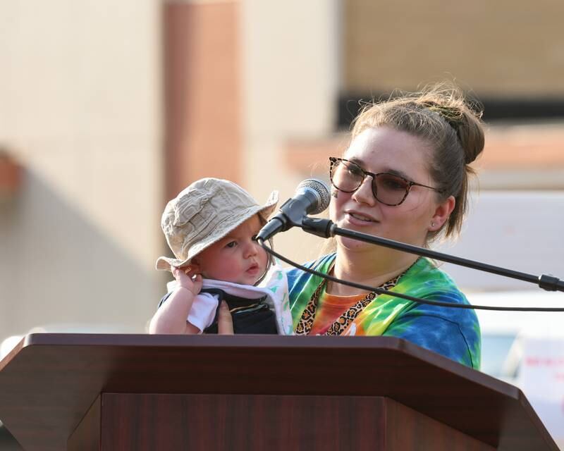 Beth Ganion and her 4-month-old son, James Ganion, speak during DeKalb Pride Fest held outside the Egyptian Theater, 135 N. Second St. in DeKalb on Thursday, June 22, 2023.