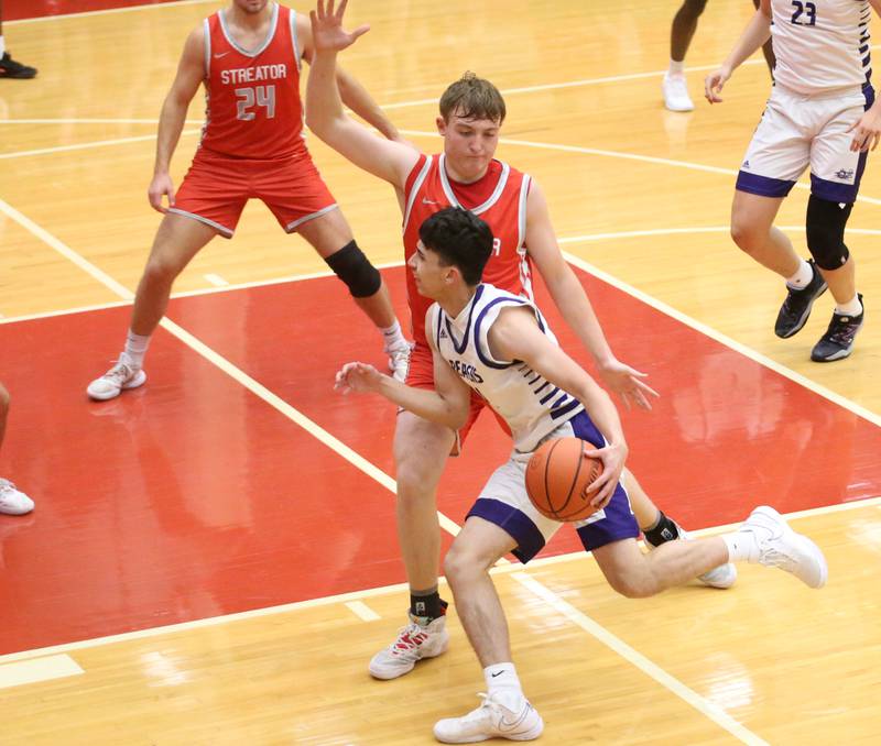 Plano's Eric Cano runs by Streator's Nolan Lukach to score a basket during the Dean Riley Shootin' The Rock Thanksgiving Tournament on Monday, Nov. 20, 2023 at Kingman Gym.