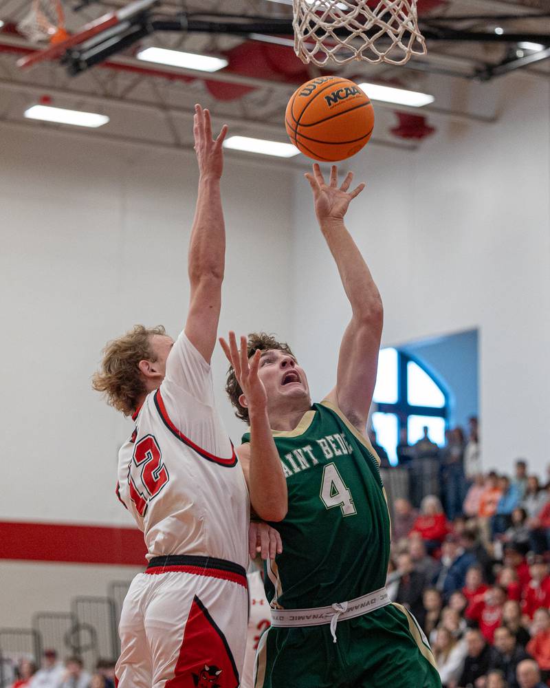 St. Bede's Gino Ferrari (4) shoots ball in paint as Hunter Edgcomb (12) of Hall attempts to contest shot on Saturday, January 31, 2026 at Hall High School in Spring Valley.