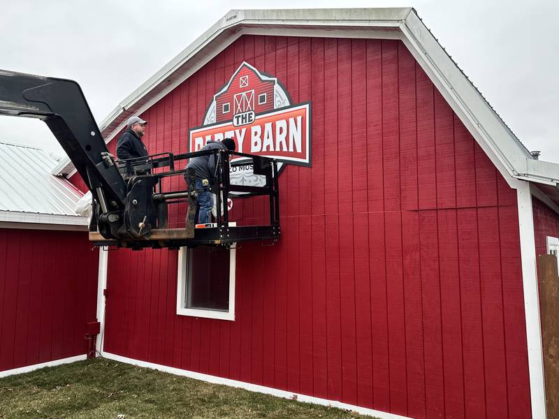 Workers install signage on the Volo Museum's new Party Barn at 27582 Volo Village Road. The space will be available to accommodate private parties starting in March. Package details are available at volofun.com.