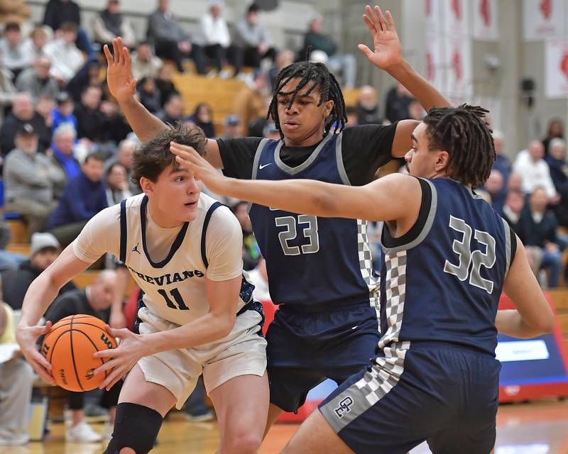 New Trier’s Matthew Logue is double teamed by Oswego East’s Mason Lockett (23) and Alton Bullock (32) during a When Sides Collide Shootout game on January 24, 2026 at Benet Academy in Lisle.