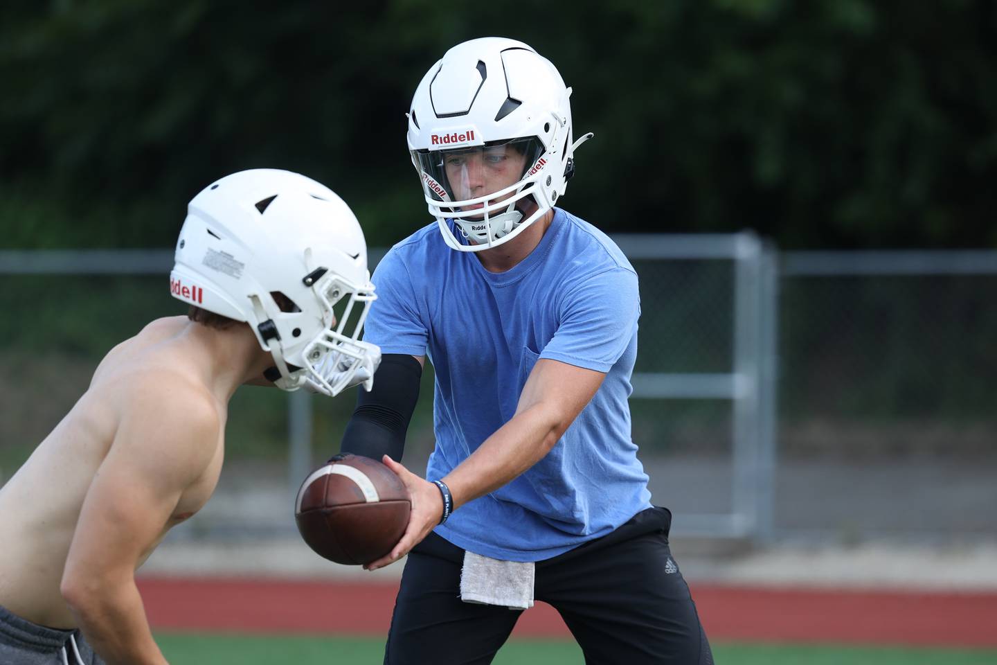 Providence’s Colin Sheehan works on handoff drills during the first day of practice on Monday, Aug. 7, 2023 in New Lenox.