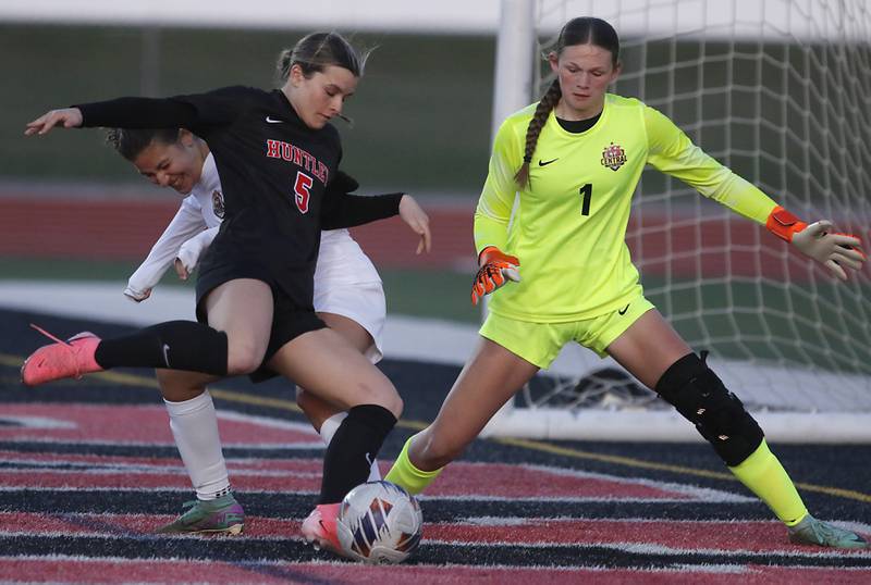 Huntley's Maizie Nickle (center) tries to take a shot on goal as Crystal Lake Central's Kira Stavropoulos (left) and goalkeeper Crystal Ryleigh Smith (right) defended during a Fox Valley Conference  soccer match on Tuesday, April 15, 2025, at Huntley High School.