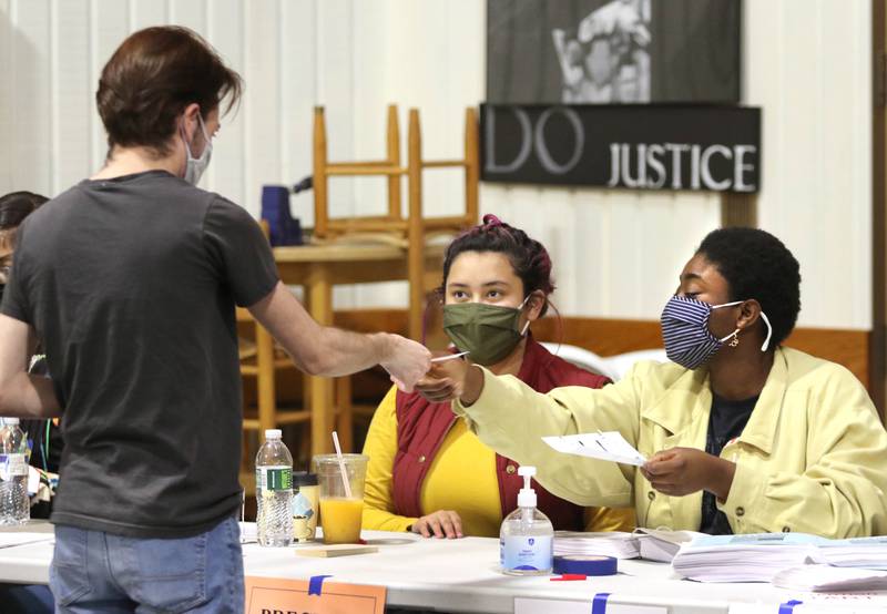 Leo Buis checks in with election judges Khadijah Nahi (left) and Gaelle Grace prior to casting his ballot Tuesday at the polling place inside the Westminster Presbyterian Church on Annie Glidden Road in DeKalb.