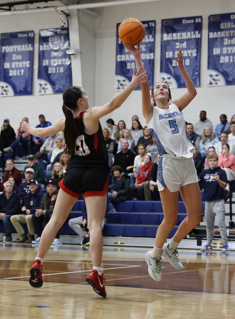 Nazareth's Sophia Towne (5) finger rolls the ball into the basket during a girls varsity basketball game between Benet and Nazareth academies on Saturday, Dec. 14, 2024 in La Grange Park.