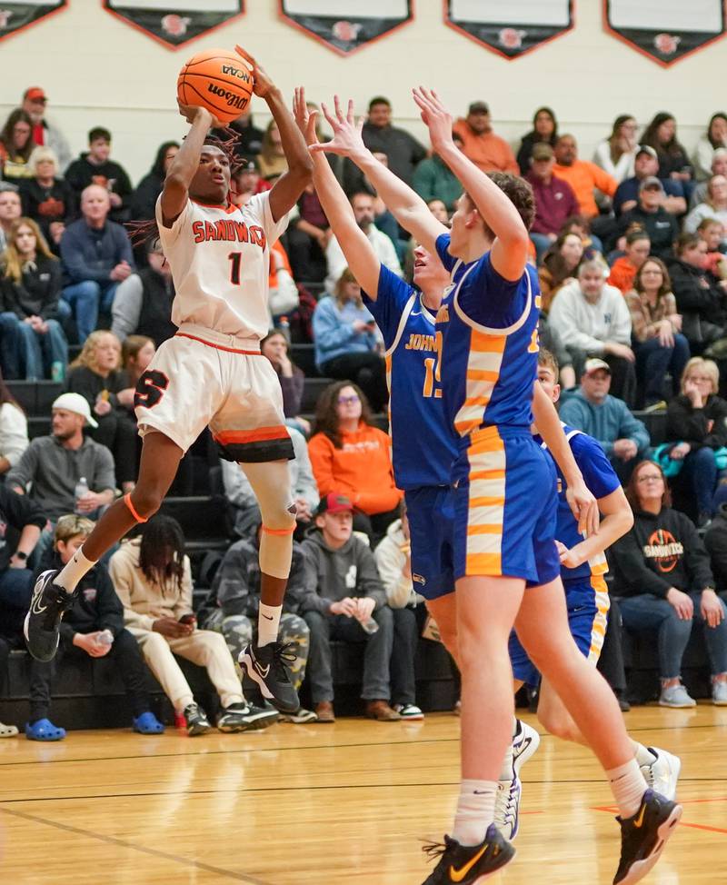 Sandwich's Simeion Harris (1) shoots a jumper along the baseline against Johnsburg's Ashton Stern (15) during a basketball game at Sandwich High School on Friday, January 31, 2025.