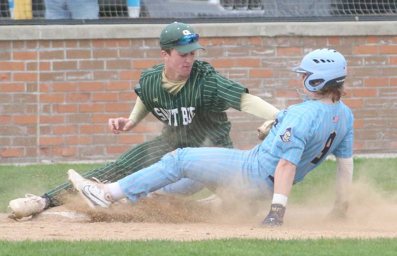 St. Bede's AJ Hermes tags out Marquette's Jackson Higgins as he attempts to slide into third base at Masinelli Field on Thursday, April 18, 2024 in Ottawa.