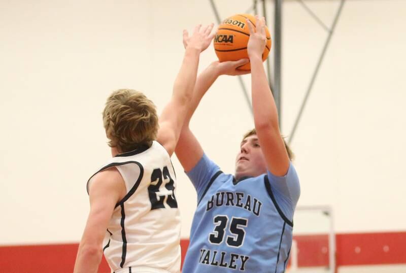 Bureau Valley's Brad Schoff shoots a jump shot over Fieldcrest's Jordan Heider during the 50th annual Colmone Classic on Monday, Dec. 9, 2024 at Hall High School.