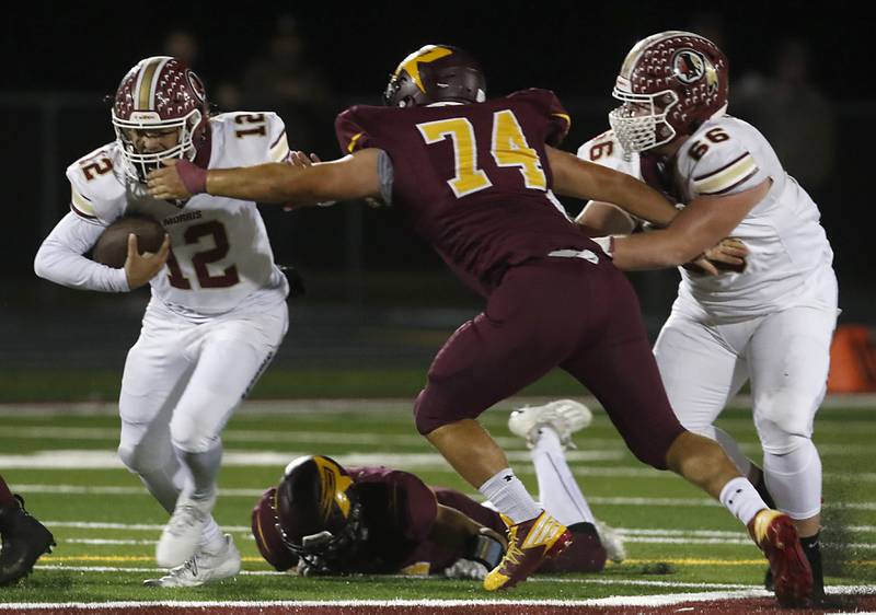 Morris’ Carter Button tries to avoid the tackle of Richmond-Burton's Jacob Gray during a Kishwaukee River Conference / Interstate 8 Conference crossover football game Friday, Sept. 30, 2022, between Richmond-Burton and Morris at Richmond-Burton Community High School in Richmond.