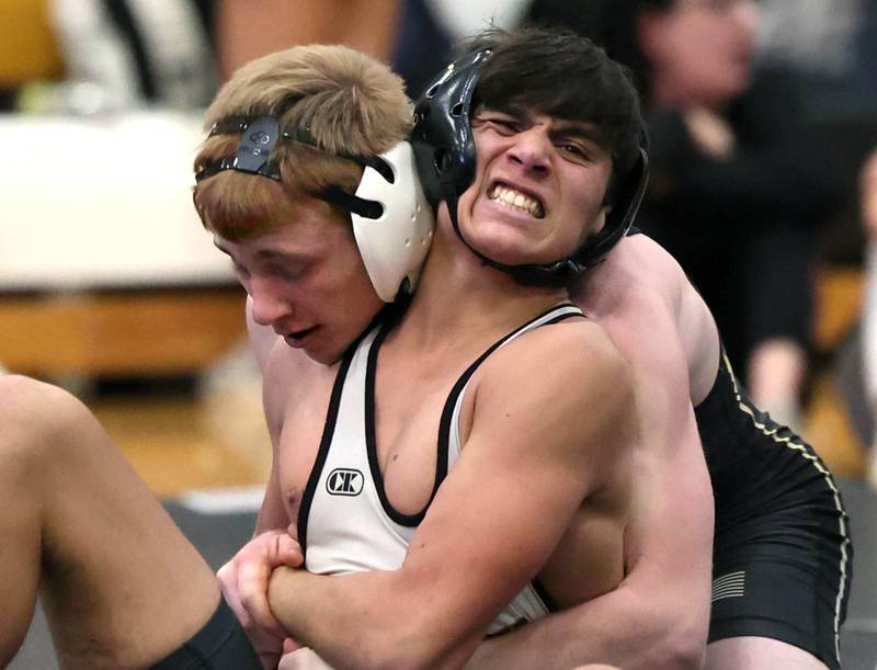 Sycamore’s Thomas Lind (left) wrestles Kaneland’s John Havron during their 132 pound match Thursday, Jan. 9, 2025, at Sycamore High School.
