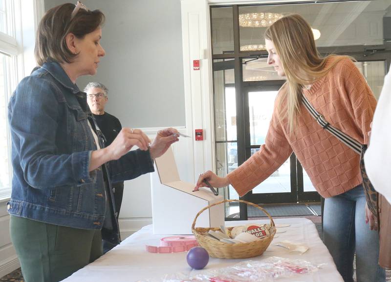 Haley Duncan registers with Shaw Local Radio advertising executive Michelle Soderholm while entering the Shaw Local Radio Bridal and Event Expo on Sunday, Feb. 23, 2025 at Senica's Oak Ridge in La Salle.
