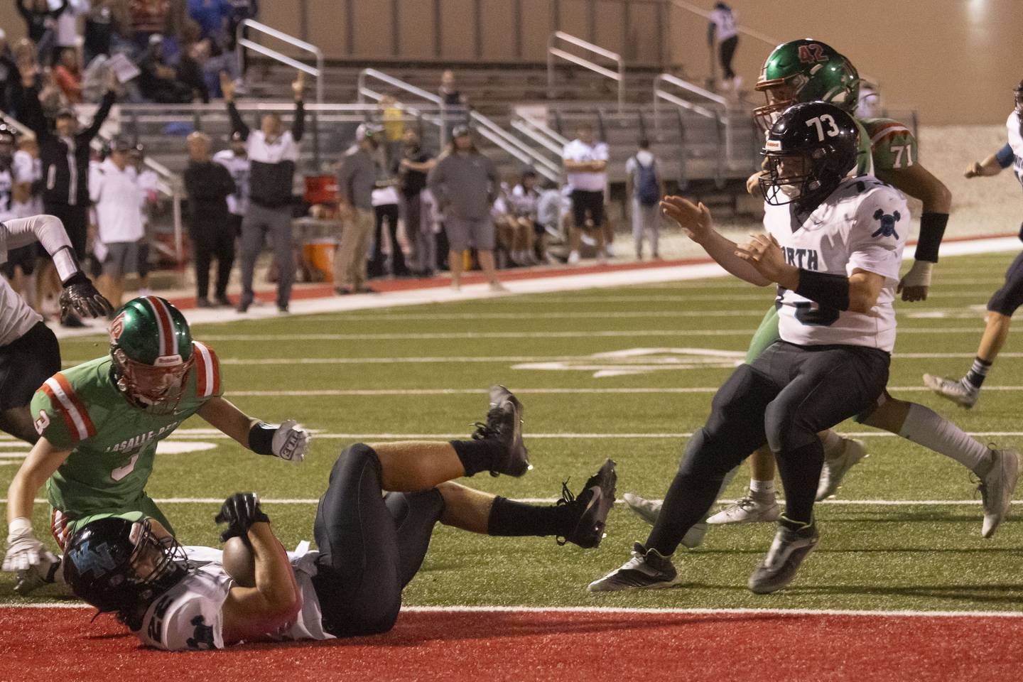 Woodstock North's Parker Halihan rolls into the end zone for a touchdown against L-P at Howard Fellows Stadium on Friday, Sept. 8, 2023.