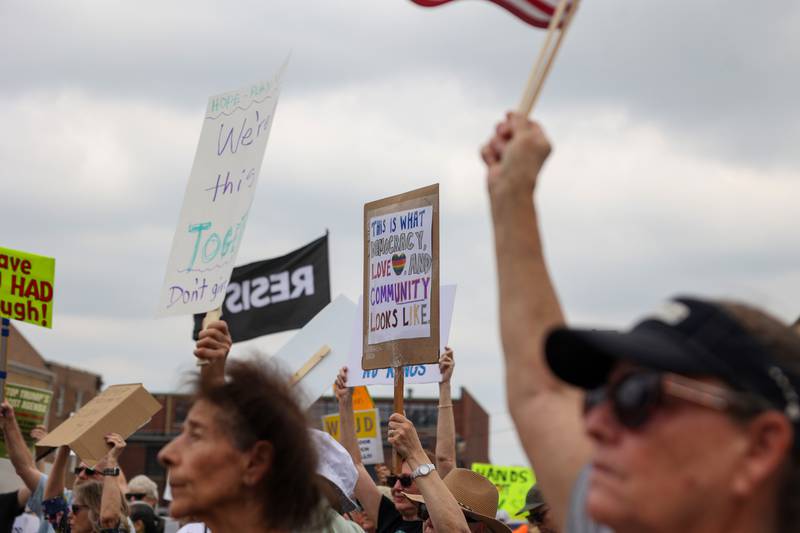 Protesters hold signs as approximately 500 people gathered at the Kankakee County Courthouse for a ‘No Kings’ rally in Kankakee on Saturday, June 14, 2025, to protest actions by President Donald Trump.