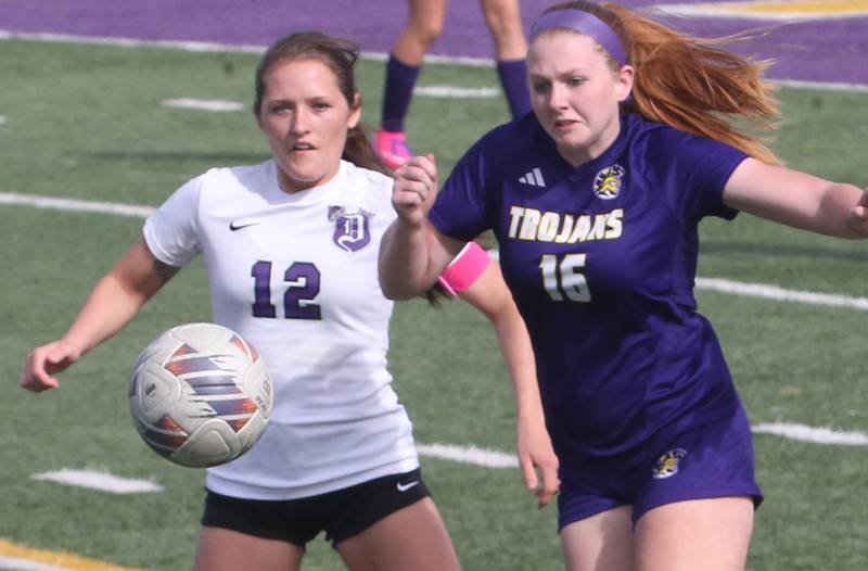 Dixon's Avery Burmeister and Mendota's Elaina Reddin chase after the ball on Wednesday, May 1, 2024 at Mendota High School.