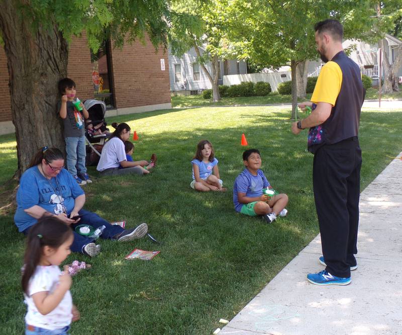 A magician shows families tricks Saturday, June 3, 2023, during the Summer Reading Kick-Off Party at Reddick Library in Ottawa.