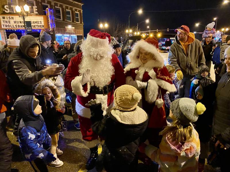 Santa Claus and Mrs. Claus were swarmed by eager children excited to get a hug, high five or chat in before marching down State Street in downtown Sycamore as part of Discover Sycamore's annual Walk with Santa on Friday, Dec. 1, 2023.