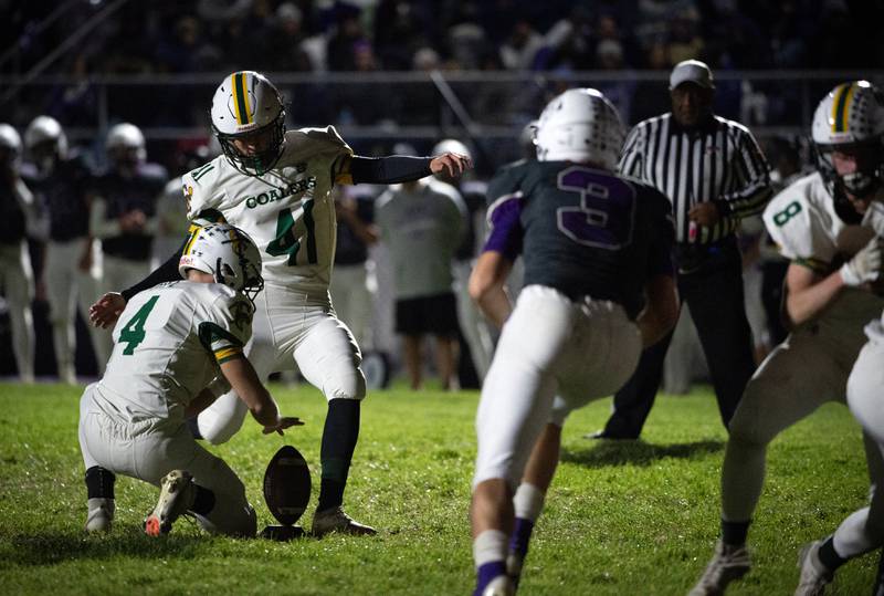 Coal City's Mason Hamilton kicks an extra point while Carter Gill releases his hold on the ball in a game against Wilmington on Friday, October 24, 2025.