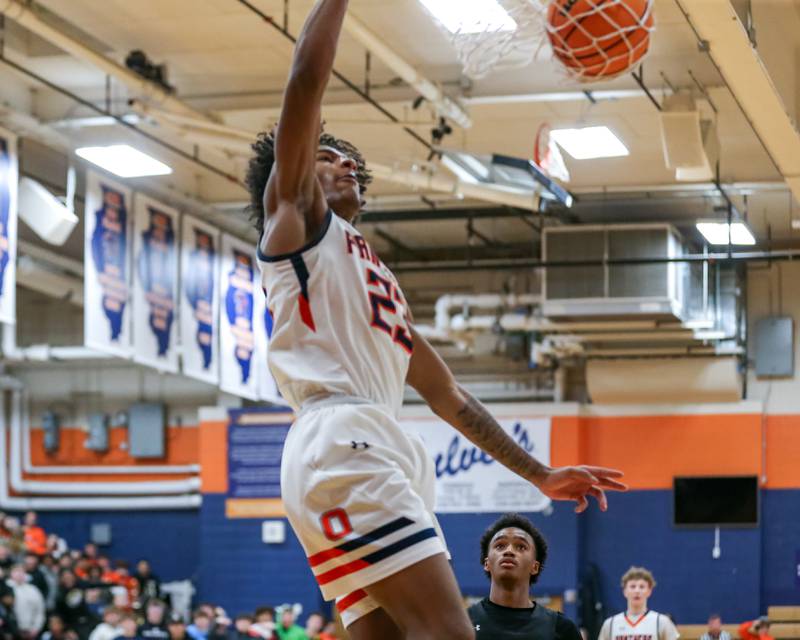 Oswego's Dasean Patton (23) dunks during their basketball game between Yorkville at Oswego, Tuesday Dec 10, 2024 in Oswego.